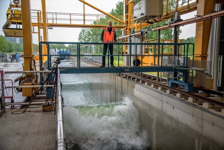 <em>A researcher at the The Deltares Research Institute in Delft runs a test in the Delta Flume, a 300 meter-long wave machin