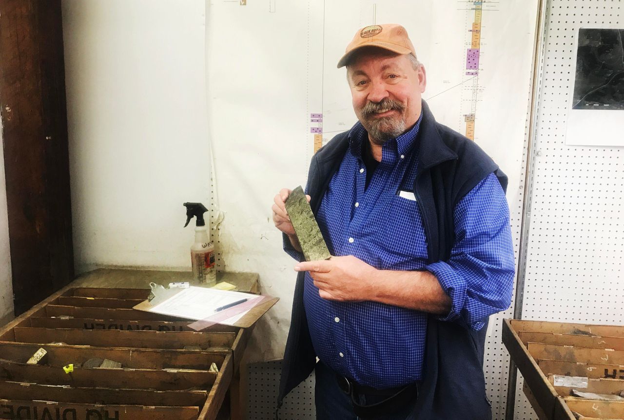 Jerry Zieg, senior vice president of Sandfire Resources America, holds up a copper-laden chunk of rock at the company's office in White Sulphur Springs.