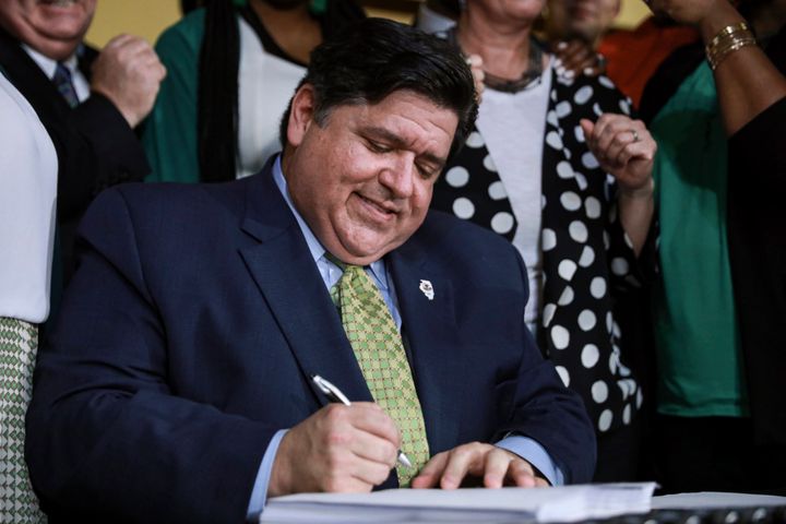Gov. J. B. Pritzker signs a bill that legalizes adult-use cannabis in the state of Illinois at Sankofa Cultural Arts and Business Center in Chicago on June 25. Illinois becomes the 11th to legalize the adult-use of recreational marijuana.
