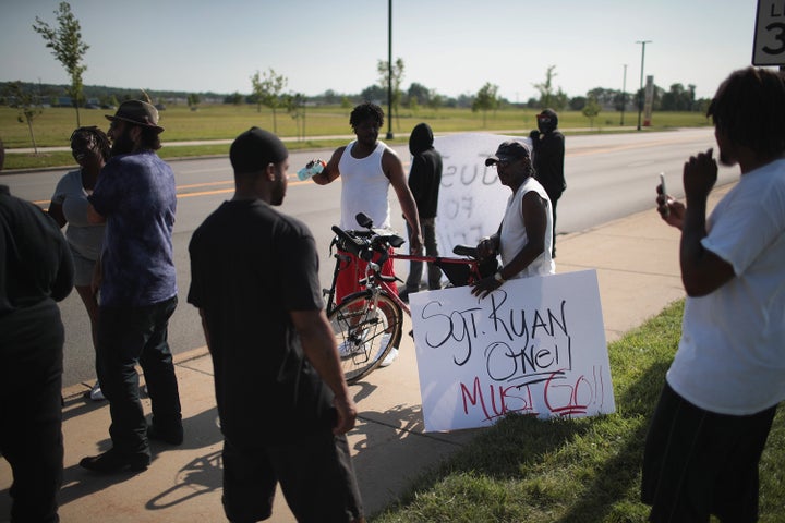 Demonstrators protest the shooting death of Eric Logan outside of the South Bend Police Station following his funeral on June