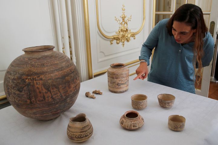 Archaeologist Aurore Didier points to some artefacts amongst the 445 artefacts from the 2nd and 3rd millennium BC which were seized by French customs between 2006 and 2007, before being returned by French authorities to Pakistan, during a ceremony at the Embassy of Pakistan in Paris, France, July 2, 2019