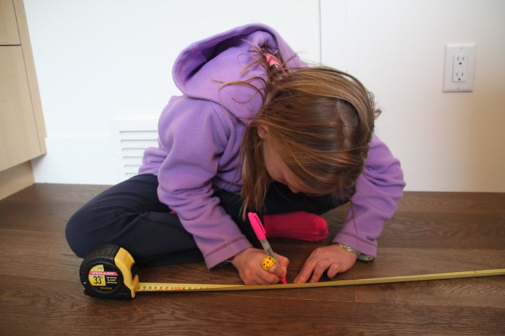 Nora Keegan, 10, marks the height of air dryers on her measuring tape.