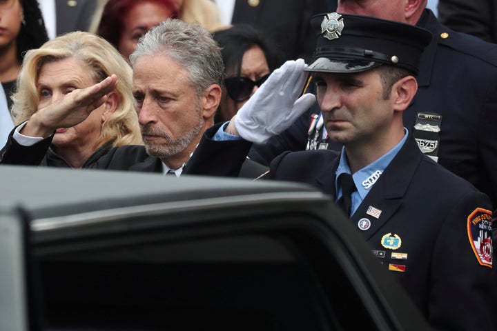 Comedian Jon Stewart salutes the casket of former NYPD detective Luis Alvarez during a funerary procession on Wednesday.
