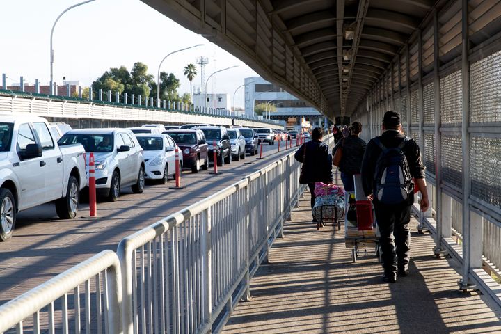 People walk across a bridge on the US/Mexico border between Laredo, Texas, and its sister city Nuevo Laredo in the Mexican state of Tamaulipas on Jan. 13, 2019.