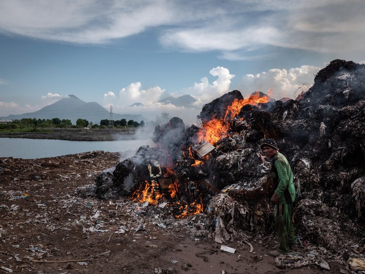 A man burns plastic waste at a import plastic waste dump in Mojokerto on Dec. 4, 2018, in Mojokerto, East Java, Indonesia.