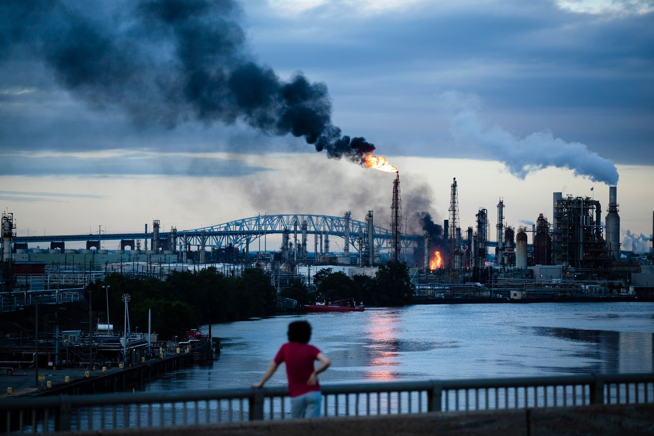 A South Philly resident watches as the Philadelphia Energy Solutions refinery goes up in flames on June 21. 