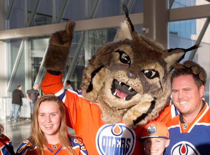 Hunter, the Edmonton Oilers' mascot, poses with fans. 