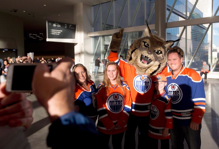 Hunter, the Edmonton Oilers' mascot, poses with fans. 