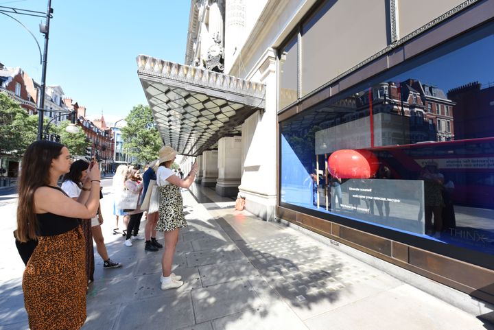 Passers by snapping the new Thinx window.