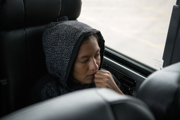 A 14-year-old girl from El Salvador recently released from federal detention with fellow Central American migrants sits on a bus before departing a bus depot on June 11, 2019, in McAllen, Texas. 