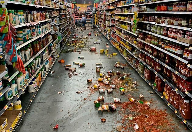 Food that fell from the shelves litters the floor of an aisle at a Walmart following an earthquake in Yucca Yalley, Calif., on Friday, July 5, 2019.