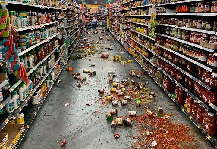 Food that fell from the shelves litters the floor of an aisle at a Walmart following an earthquake in Yucca Yalley, Calif., on Friday, July 5, 2019.