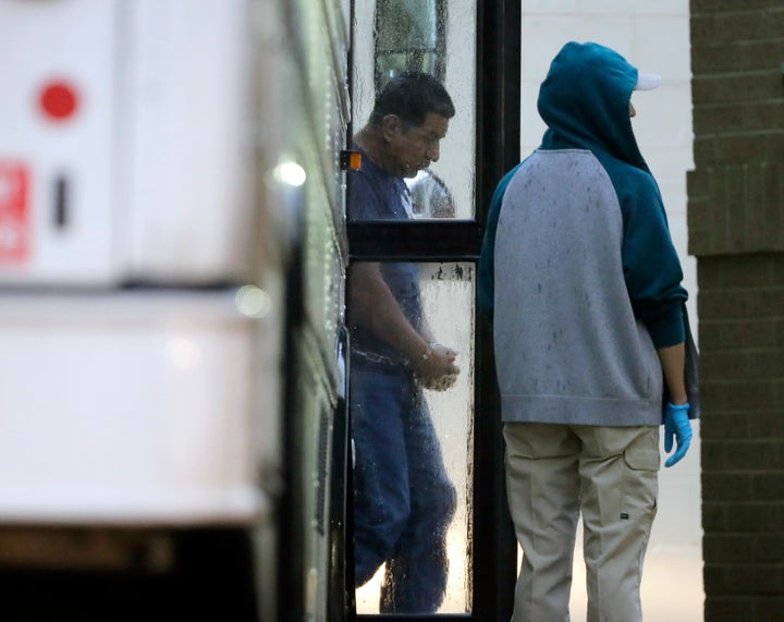 Immigrants in handcuffs and ankle chains arrive at the Federal Courthouse in McAllen, Texas, for hearings on June 21, 2018.