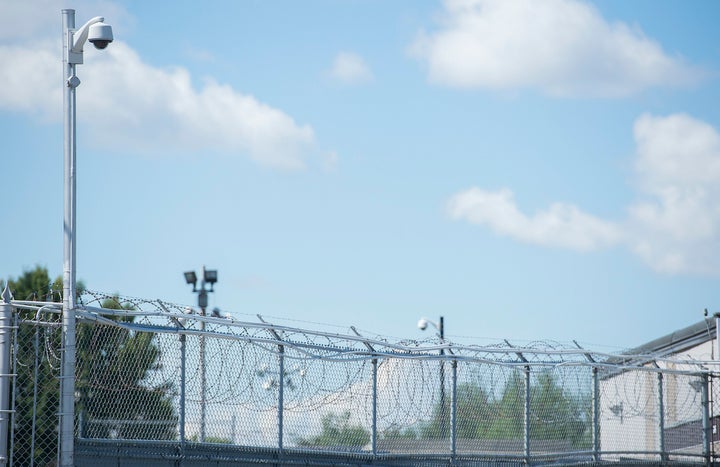 Barbed wire surrounds the perimeter of an immigration holding centre in Laval, Que. on Aug. 15, 2016.