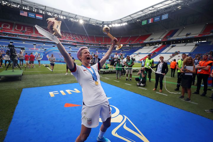 Rapinoe celebrates with her trophies as the best player and top scorer of World Cup.