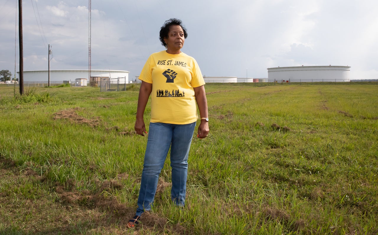 Sharon Lavinge founder of RISE St. James in font of oil storage tanks in St. James Parish.