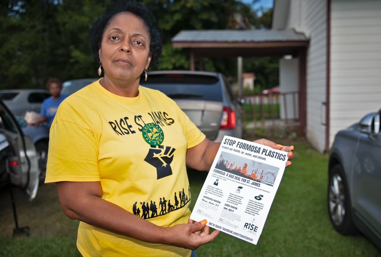 Sharon Lavinge founder of RISE St. James in front of the Mt. Triumph Baptist Church with a flyer about the proposed Formosa plant.