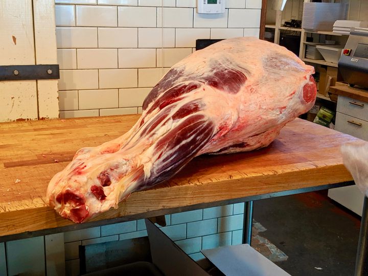 A leg of beef awaits being butchered at Western Daughters in Denver.