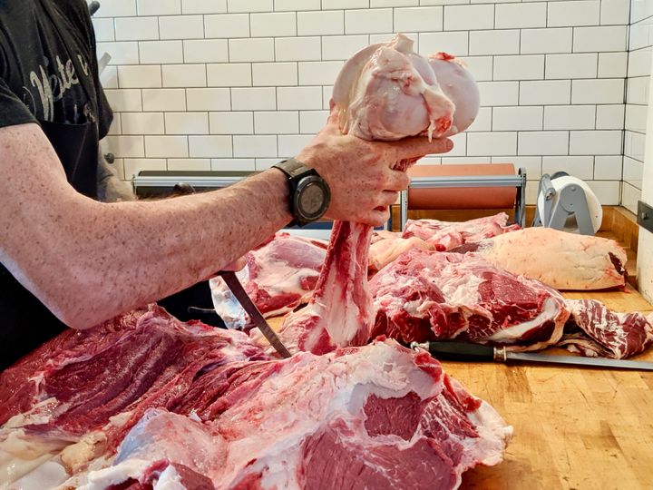 A butcher at Western Daughters in Denver breaks down a cow.