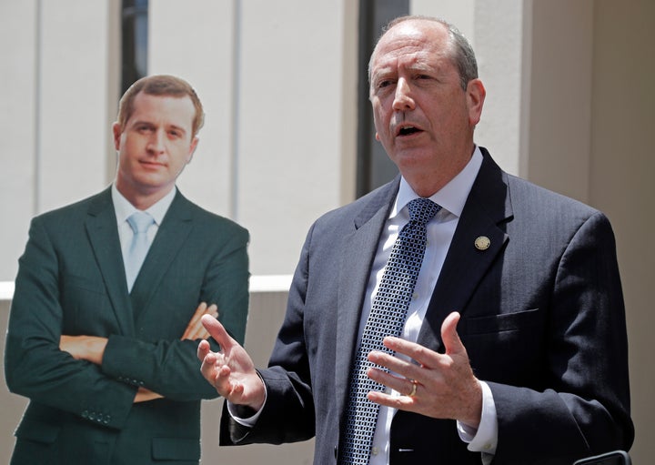 North Carolina State Sen. Dan Bishop, the Republican nominee in North Carolina's 9th Congressional District, speaks beside a cutout of Democrat Dan McCready in May.