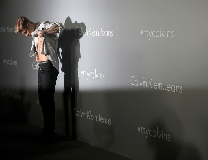 Justin Bieber inspecting his abs at a promotional event for Calvin Klein in Hong Kong in 2015.