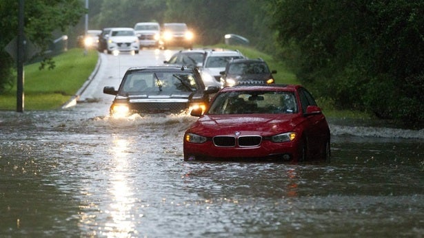 Drivers in Kingwood, Texas, wade through flooded roads in a May thunderstorm. Federal authorities are preparing to roll out a