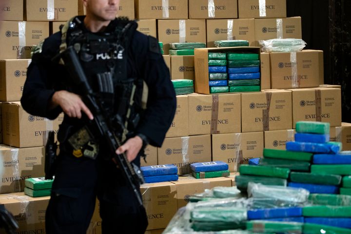 An officer stands guard over some of the cocaine seized from a ship at the Port of Philadelphia.