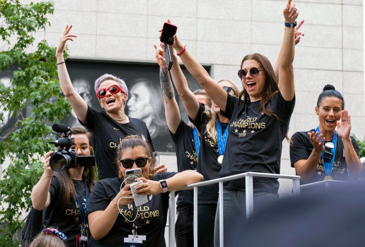 Member of the U.S. women's soccer team, including Megan Rapinoe, rear left, and Alex Morgan, right foreground, stand on a float before being honored with a ticker tape parade along the Canyon of Heroes, Wednesday, July 10, 2019 in New York. 