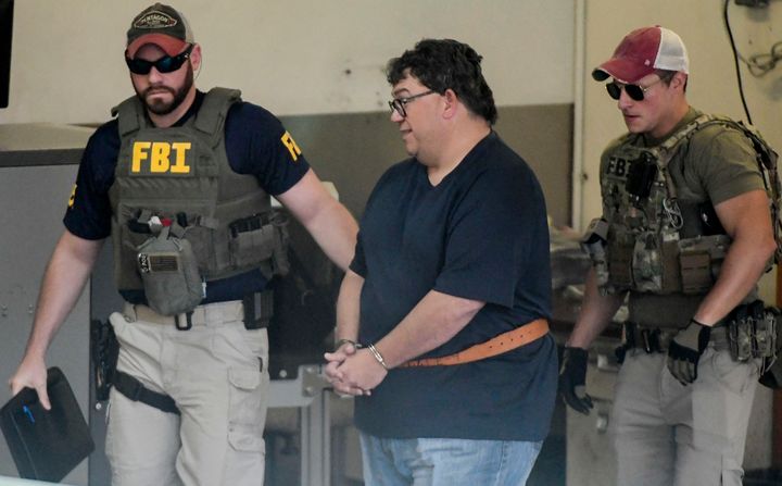 FBI agents escort businessman Fernando Scherrer-Caillet who was arrested in San Juan, Puerto Rico, Wednesday, July 10, 2019.