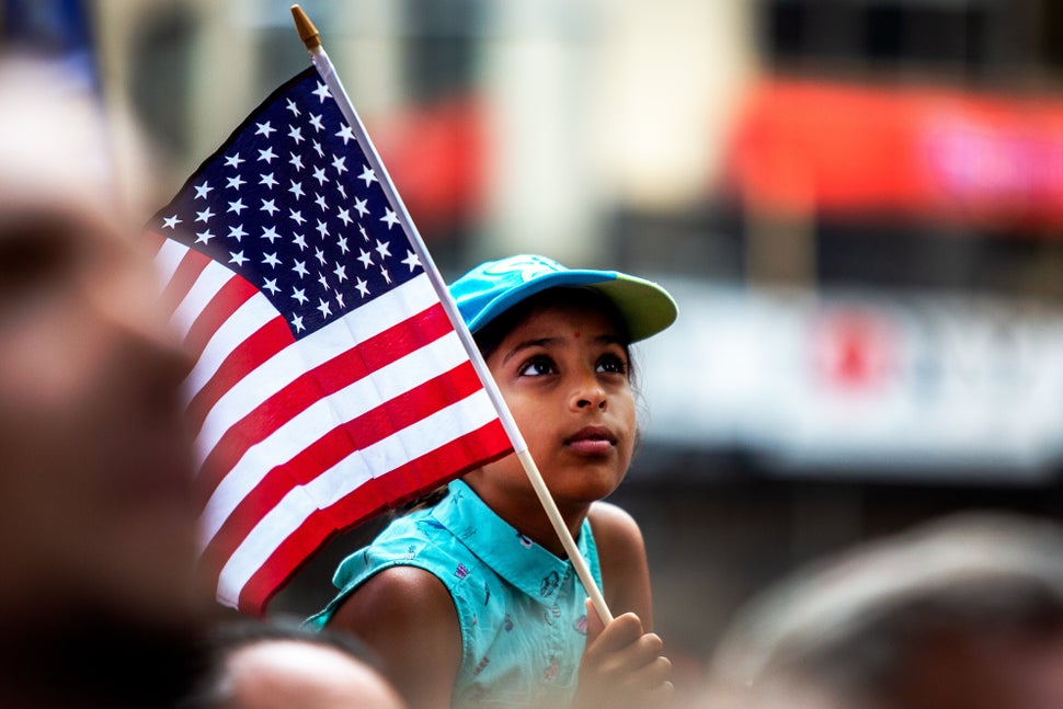 A child holds the American flag along the parade route.