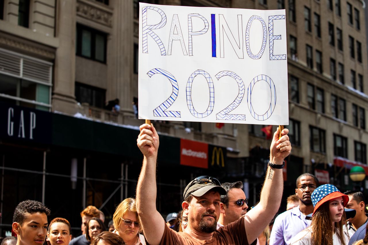 A fan holds a "Rapinoe 2020" sign as the U.S. women's soccer team makes its way up Broadway's Canyon of Heroes.