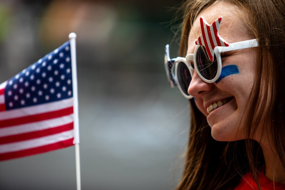 A fan waves a flag along the parade route. 