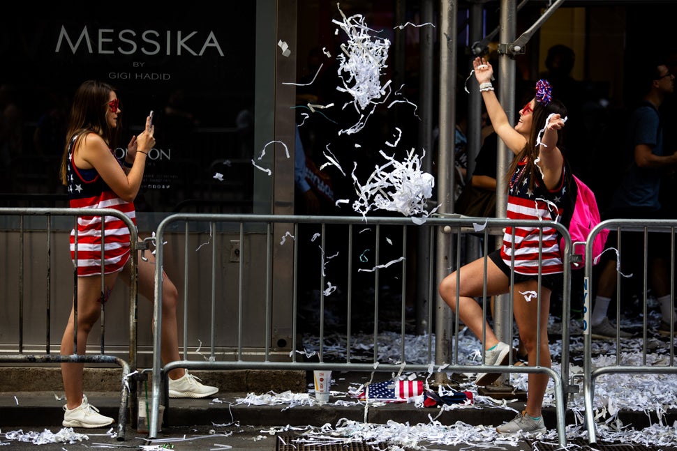 Fans take photos along the parade route.