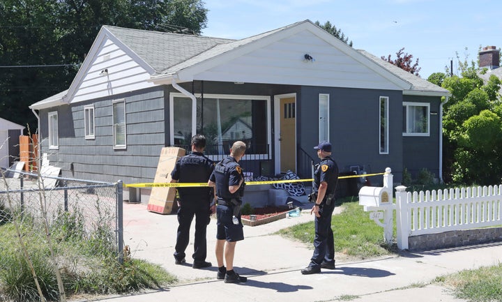 Police officers stand in front of the home of Ayoola A. Ajayi on June 28 in Salt Lake City.