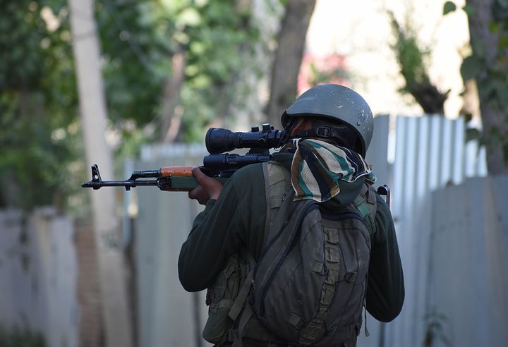 An Indian army soldier checks his rifle near the gun-battle site in Checkpora area of Budgam district on June 28, 2019.