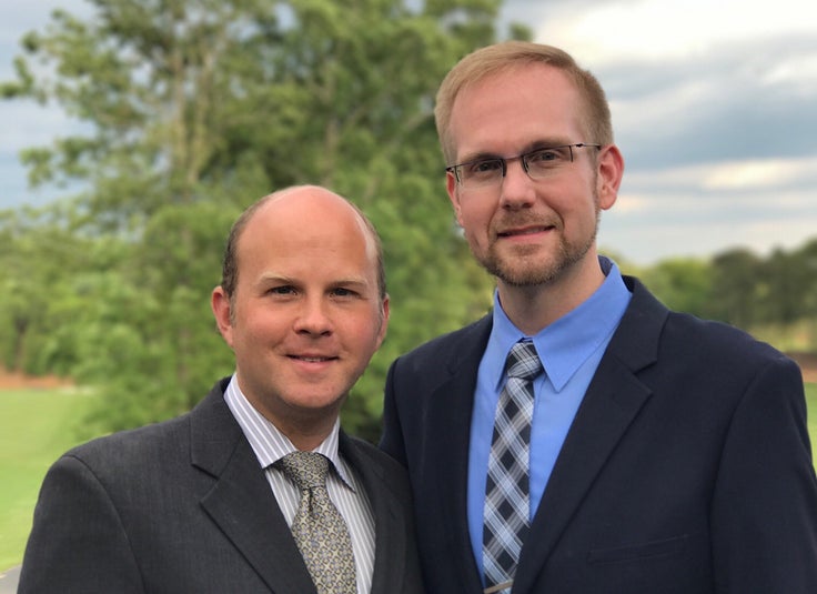 Joshua Payne-Elliott, right, and his husband, Layton Payne-Elliott, were both employed as Catholic school teachers in Indianapolis. Joshua Payne-Elliott was fired in June.