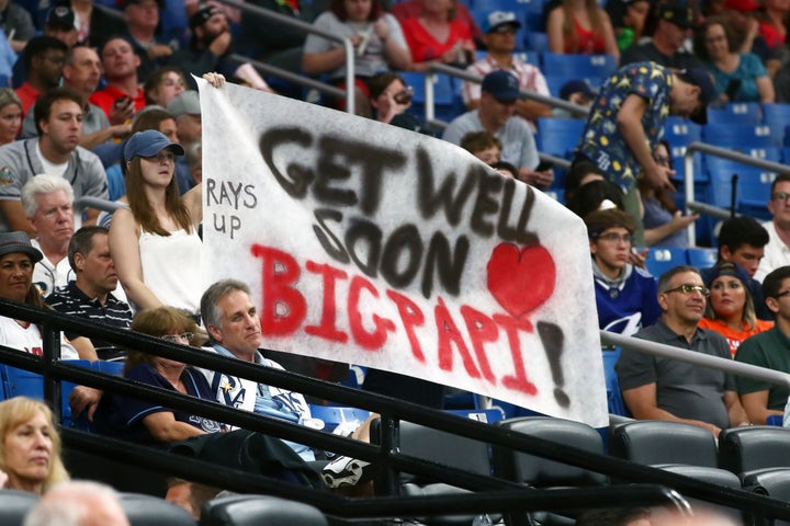 Baseball fans hold up a sign for former Boston Red Sox designated hitter David Ortiz during a game between the Tampa Bay Rays and Los Angeles Angels at Tropicana Field.