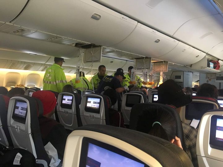 Emergency responders boarded the plane after it diverted to Hawaii two hours into the flight 