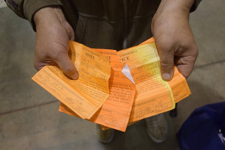 <p>‘J’ displays a small portion of his 72-hour relocation sticker collection, each warning of an impending impound. J is a vehicle resident and ‘car rancher’ – a person who lends or rents multiple vehicles to otherwise unsheltered people. April 29, 2014.</p>