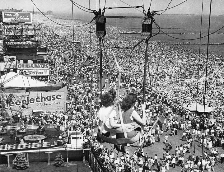 Passengers on the Parachute Jump ride see throngs of people on the boardwalk and beach at the Coney Island Amusement Park in Brooklyn, N.Y., in 1957.