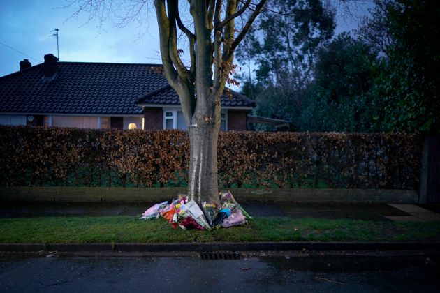 Flowers and tributes are placed in memory of Yousef on Gorse Bank Road in the village of Hale Barns