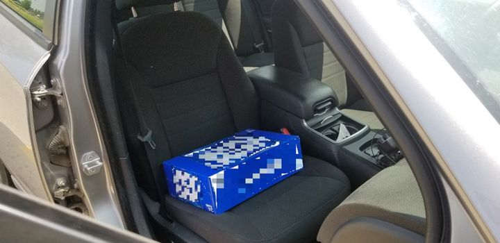 Ontario police found a two-year-old found sitting on a case of beer, as a makeshift booster seat.