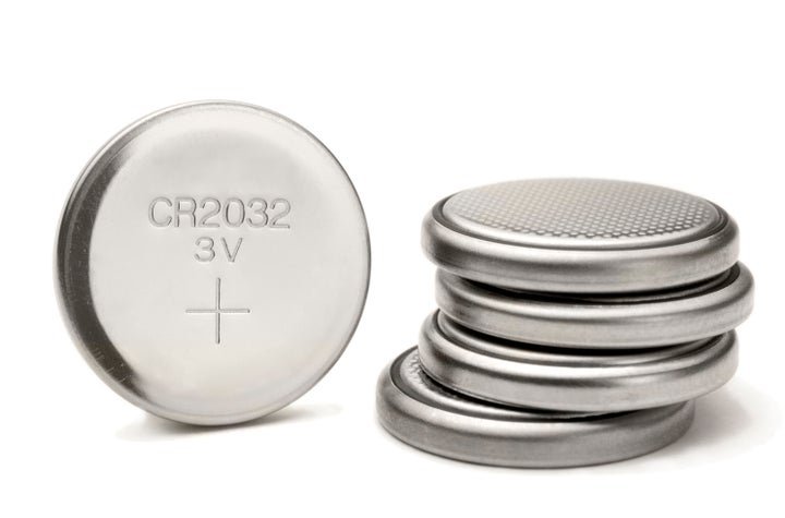 Button batteries look like small metal buttons. 