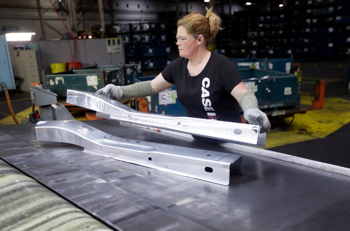 A GM worker deposits parts of a stamping machine at the company's Pontiac metallurgy center in Michigan in 2015.