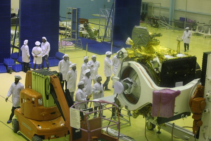 Scientists give finishing touches to the moon orbitter Chandrayaan 2 inside the clean room of the Indian space agency.