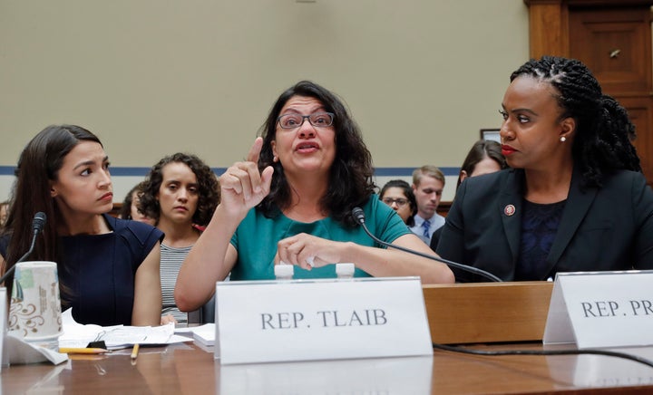 Rashida Tlaib, centre, Alexandria Ocasio-Cortez, left, and Ayanna Pressley, 