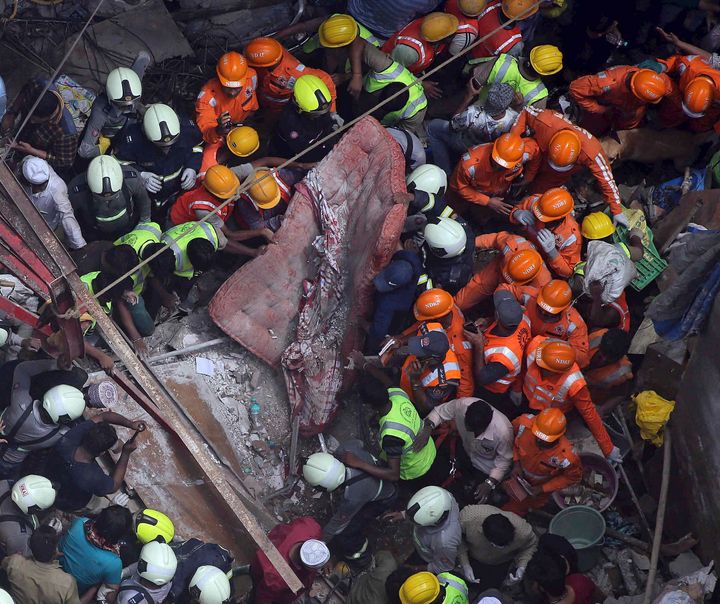Rescuers work at the site of a building that collapsed in Mumbai, on July 16, 2019. 