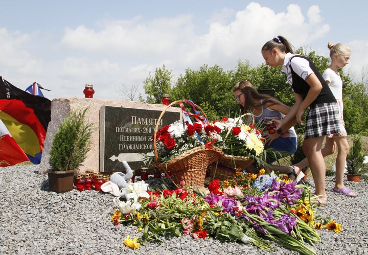 People gather near a monument to the victims of the crash in the Donetsk Region, Ukraine.