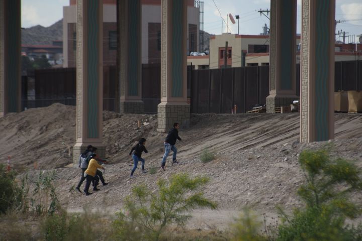 Migrants cross the Rio Bravo from Ciudad Juarez, Mexico to El Paso, Texas, to surrender to the Border Patrol on 8 May 2019.