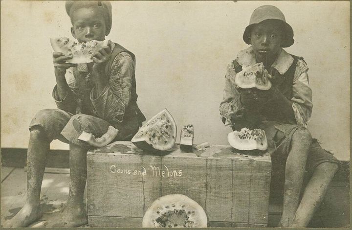 An image from 1895 depicts two black children eating wedges of watermelon.
